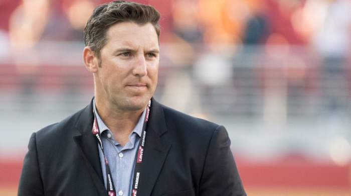 49ers executive Adam Peters looks on while on the field before a game.